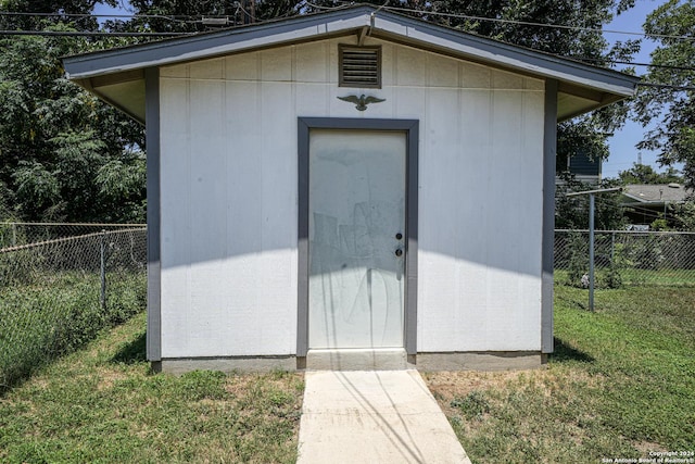 view of outbuilding with a lawn