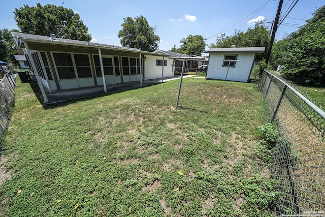 view of yard featuring a storage shed and a sunroom