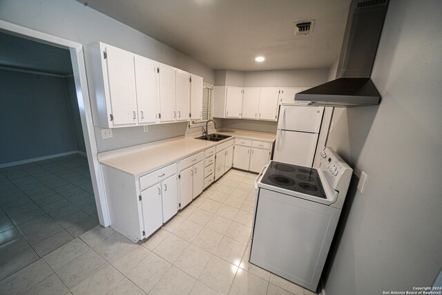 kitchen with white appliances, sink, wall chimney exhaust hood, and light tile patterned floors