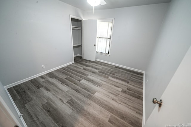 unfurnished bedroom featuring hardwood / wood-style floors and a closet