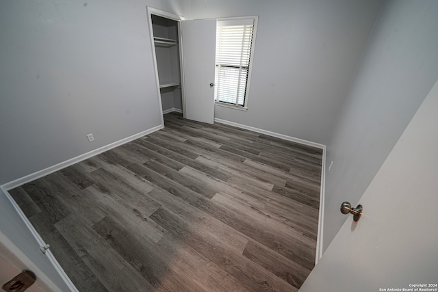 unfurnished bedroom with a closet and wood-type flooring