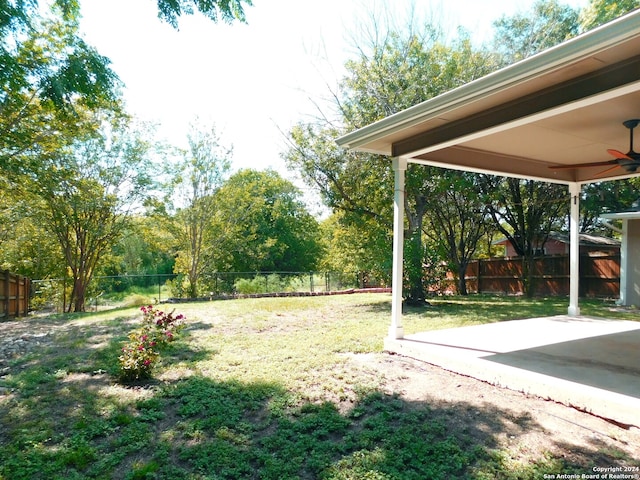 view of yard with a patio and ceiling fan