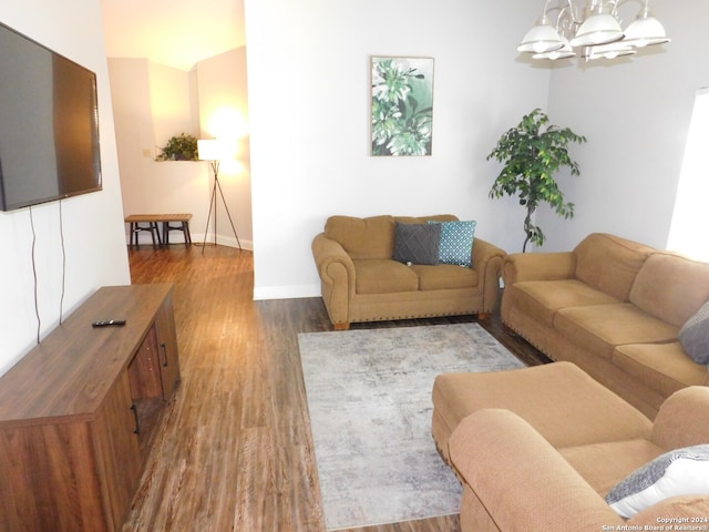 living room featuring an inviting chandelier and hardwood / wood-style floors