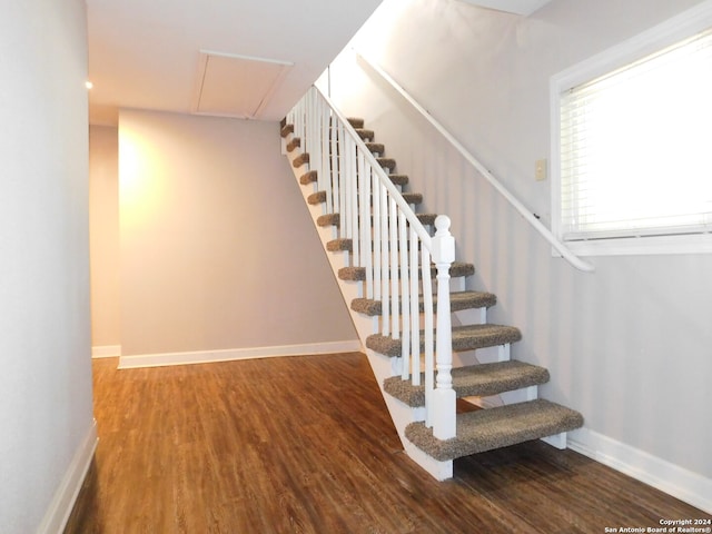 stairs featuring wood-type flooring