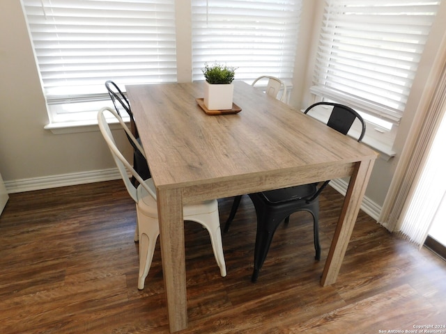 dining space with dark hardwood / wood-style floors