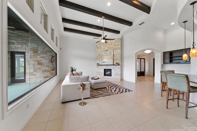 kitchen featuring sink, light stone counters, light tile patterned floors, dark brown cabinets, and a kitchen island with sink