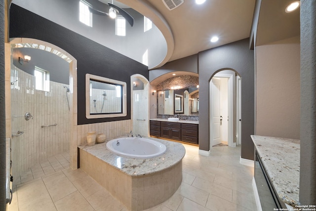 bathroom featuring vanity, tile patterned flooring, and plus walk in shower