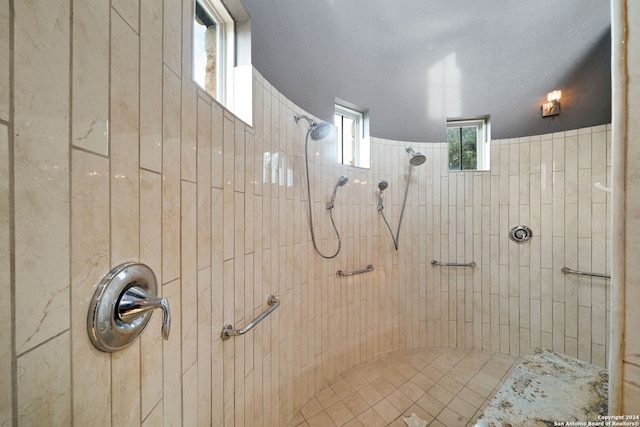 bathroom featuring a textured ceiling and tiled shower