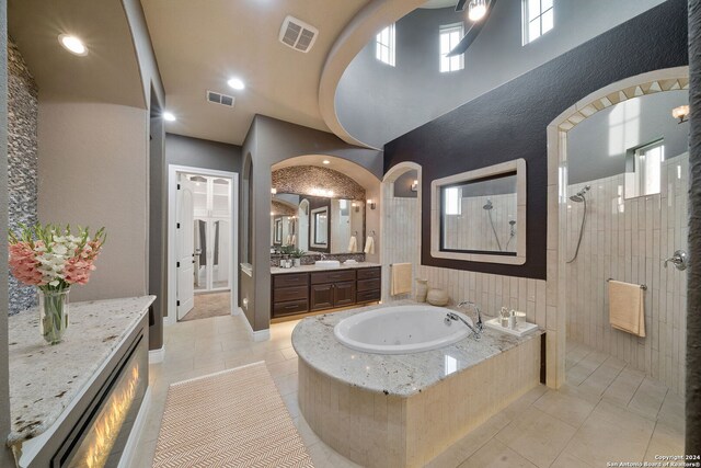 bathroom with vanity, tile patterned floors, and a washtub