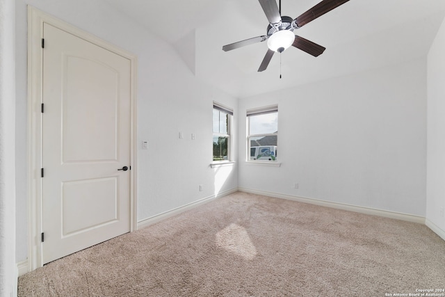 carpeted spare room with ceiling fan