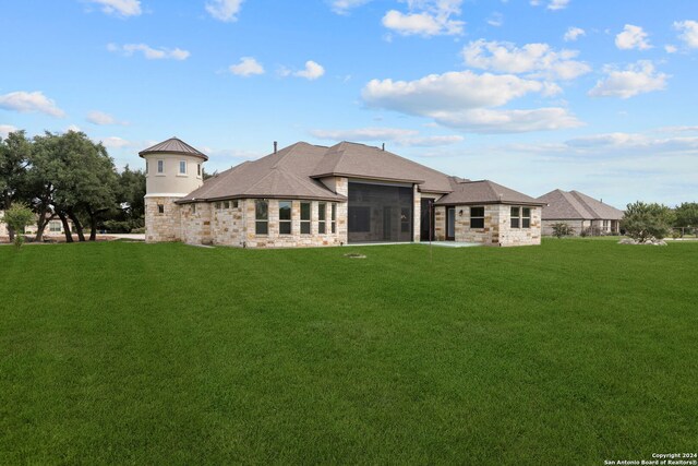 back of property featuring central AC and a lawn