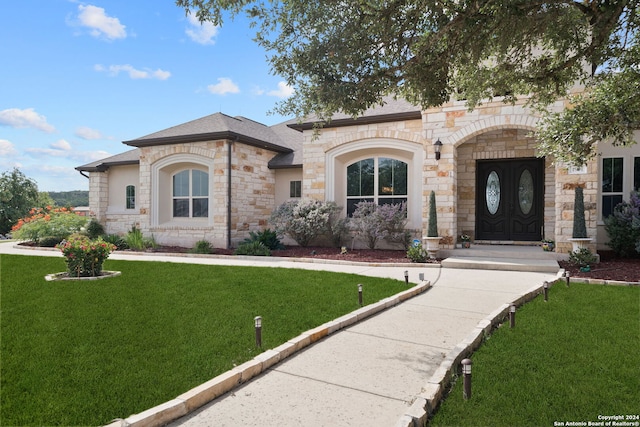 mediterranean / spanish-style house featuring a front yard