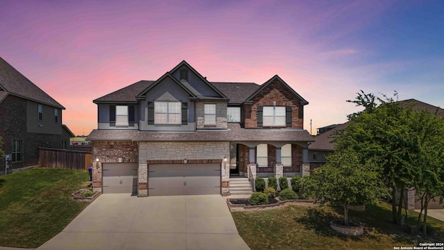 craftsman-style house with a garage and a lawn