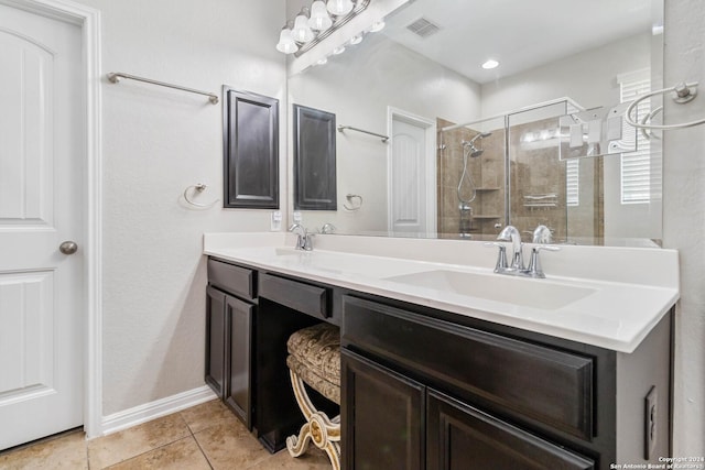 bathroom featuring vanity, tile patterned floors, and a shower with door