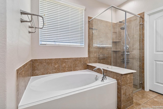 bathroom featuring shower with separate bathtub