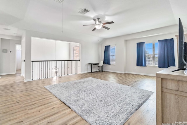 interior space with lofted ceiling, wood-type flooring, and ceiling fan