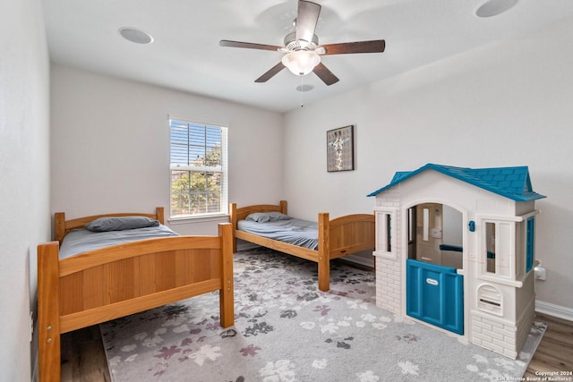 bedroom featuring ceiling fan and hardwood / wood-style floors