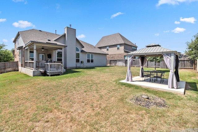 view of yard featuring a gazebo, a deck, ceiling fan, and a patio