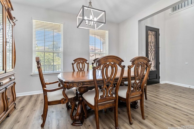 dining room featuring a notable chandelier and light wood-type flooring