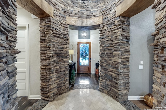 foyer entrance featuring dark hardwood / wood-style floors and a notable chandelier