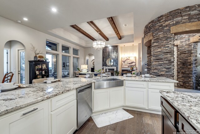 kitchen featuring dark hardwood / wood-style flooring, dishwasher, sink, white cabinetry, and beamed ceiling