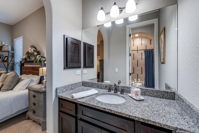 bathroom featuring a textured ceiling and vanity