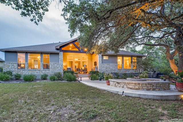 back of house with a yard and a patio