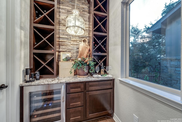 wine room with wine cooler and bar