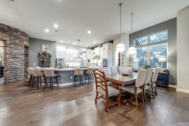 dining space with dark hardwood / wood-style floors and sink