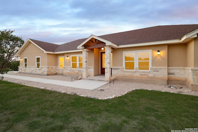 view of front facade with a patio and a yard