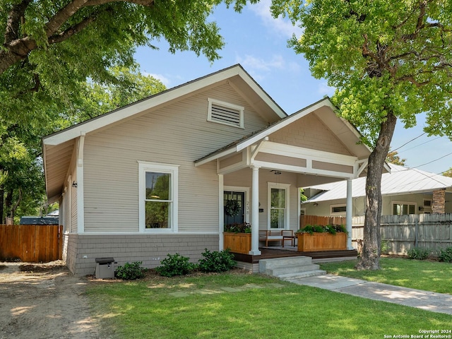 view of front of home featuring covered porch and a front yard