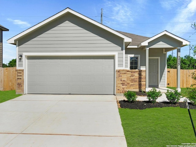 ranch-style home with a front lawn and a garage