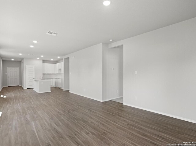 unfurnished living room featuring wood-type flooring