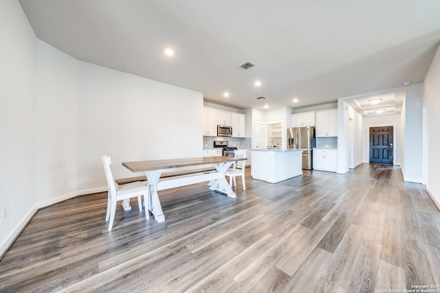 unfurnished dining area with sink and light hardwood / wood-style flooring