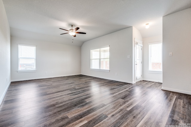 unfurnished living room featuring ceiling fan, dark wood-type flooring, and vaulted ceiling