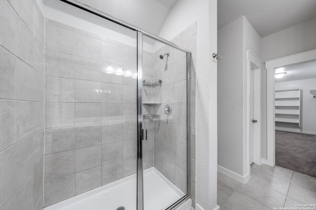 bathroom featuring an enclosed shower and tile patterned floors