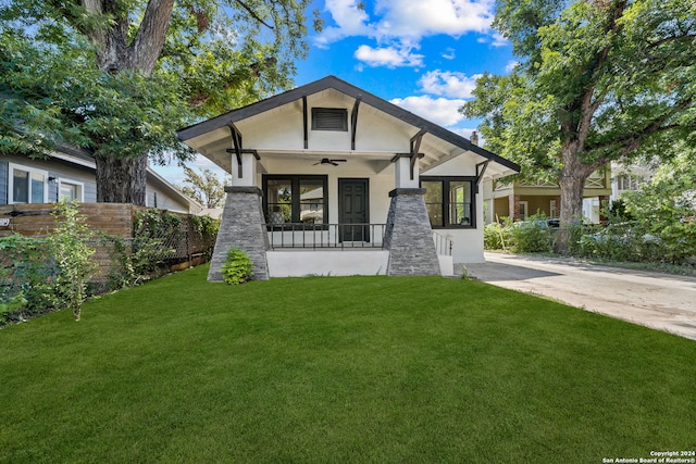 view of front of home featuring ceiling fan and a front yard