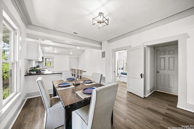 dining space with crown molding and dark hardwood / wood-style floors