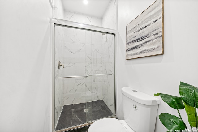 bathroom with walk in shower and toilet