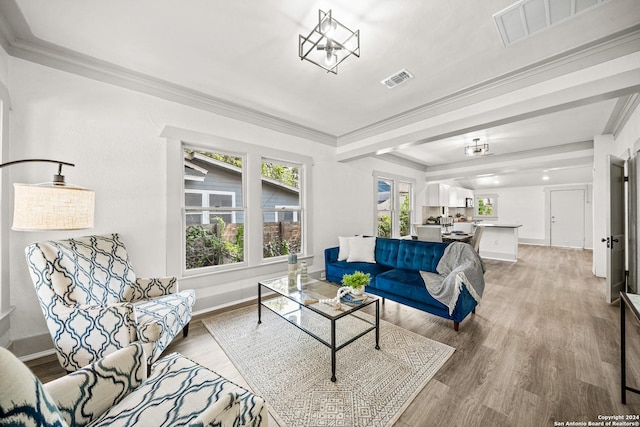 living room with crown molding and hardwood / wood-style flooring