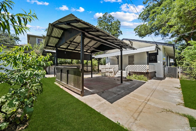 back of property with a lawn and a patio area