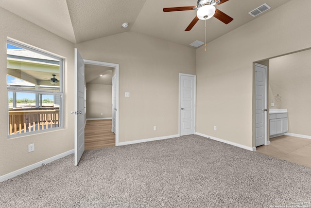 8433 Roadrunner Psge, San Antonio, TX 78222 - unfurnished bedroom with light colored carpet, a ceiling fan, baseboards, vaulted ceiling, and visible vents