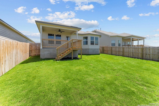 8433 Roadrunner Psge, San Antonio, TX 78222 - rear view of property with a lawn, ceiling fan, stairs, and a fenced backyard