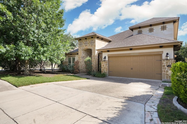 view of front of home with a garage, stone siding, concrete driveway, stucco siding, and a front lawn