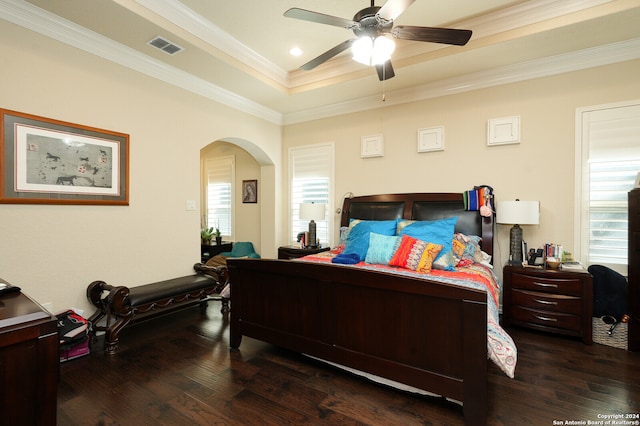 bedroom with hardwood / wood-style flooring, ceiling fan, multiple windows, and ornamental molding