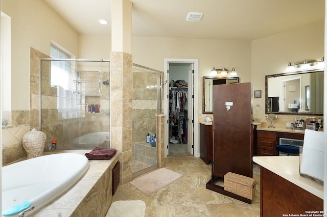 bathroom with plus walk in shower, tile patterned flooring, and vanity