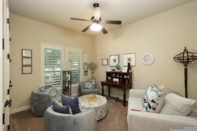 carpeted living room with ceiling fan