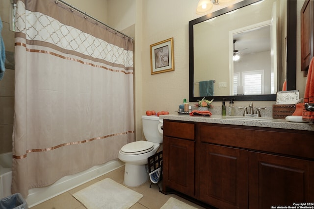 full bathroom featuring toilet, vanity, shower / bath combo with shower curtain, tile patterned floors, and ceiling fan