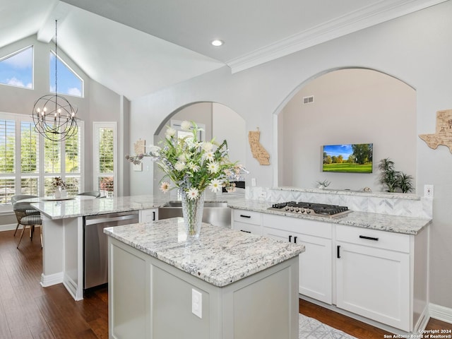 kitchen featuring light stone counters, kitchen peninsula, and dark hardwood / wood-style flooring