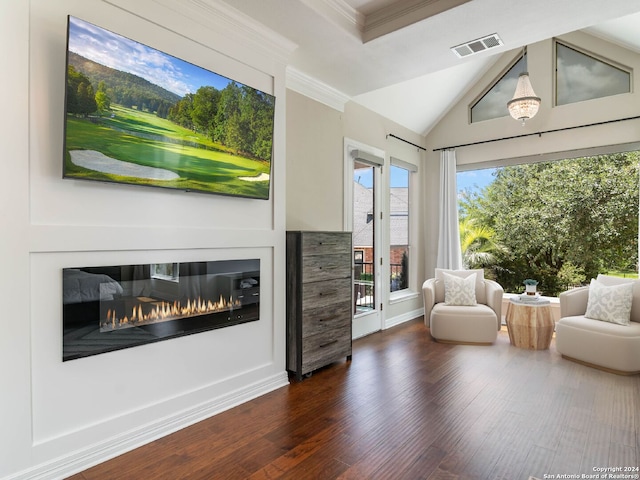 sitting room featuring lofted ceiling, dark hardwood / wood-style floors, and ornamental molding